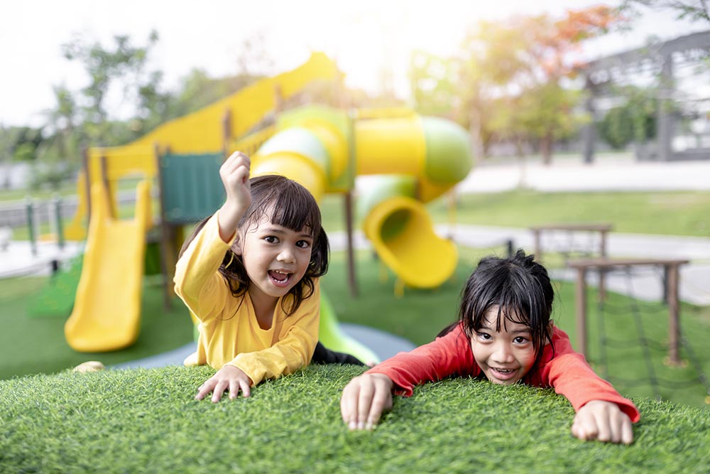 Child playing on outdoor playground. Kids play on school or kind