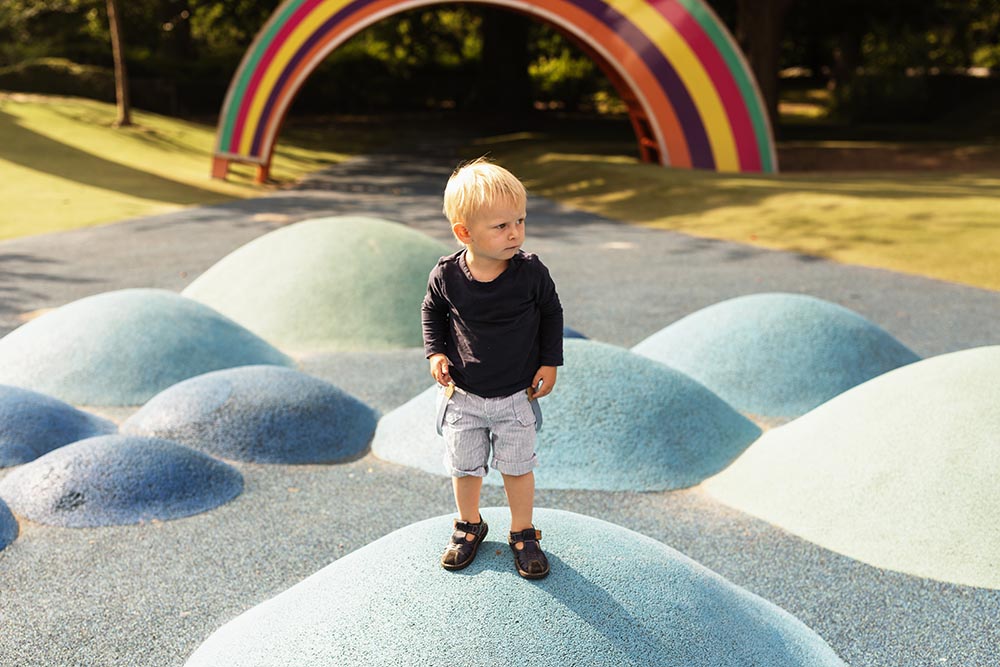 Full length of boy standing on artificial hill in playground