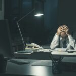 Stressed business executive working overtime