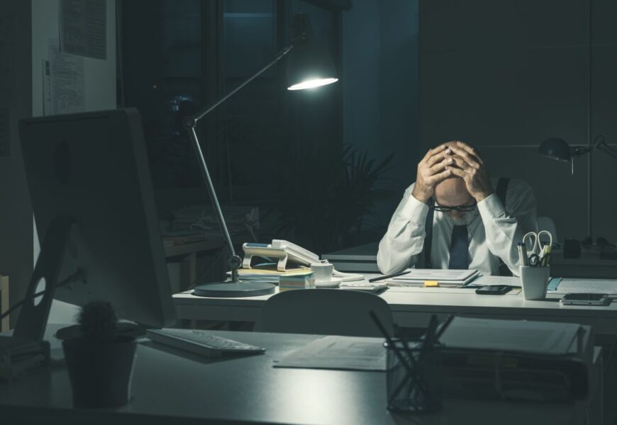 Stressed business executive working overtime