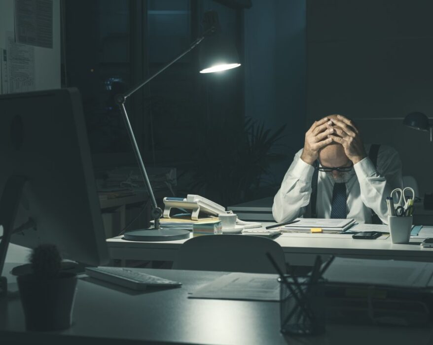 Stressed business executive working overtime