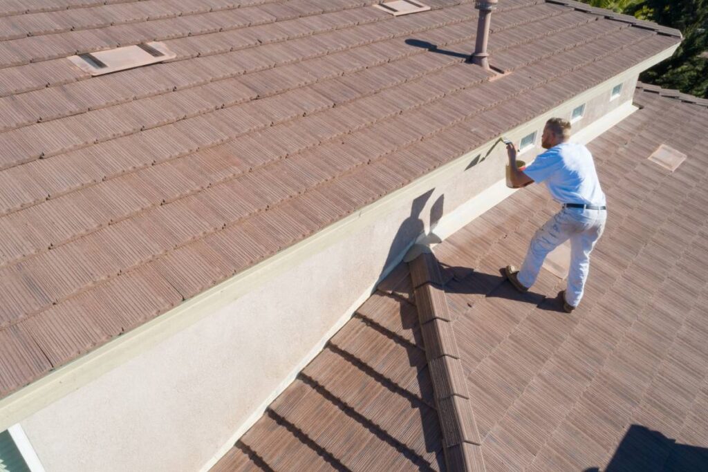 Professional Painter Using A Brush to Paint House Fascia.