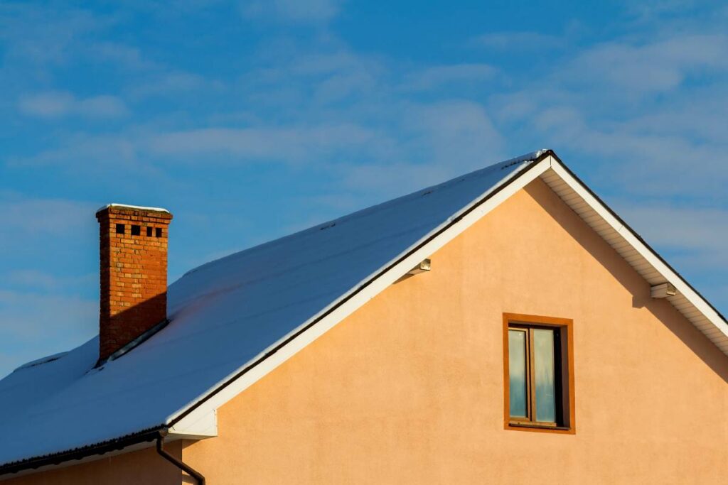 Roof of a new built house with nice window and chimney.