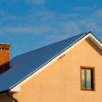 Roof of a new built house with nice window and chimney.
