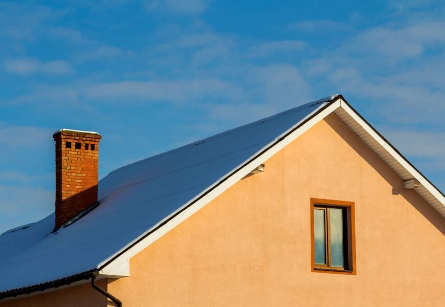 Roof of a new built house with nice window and chimney.