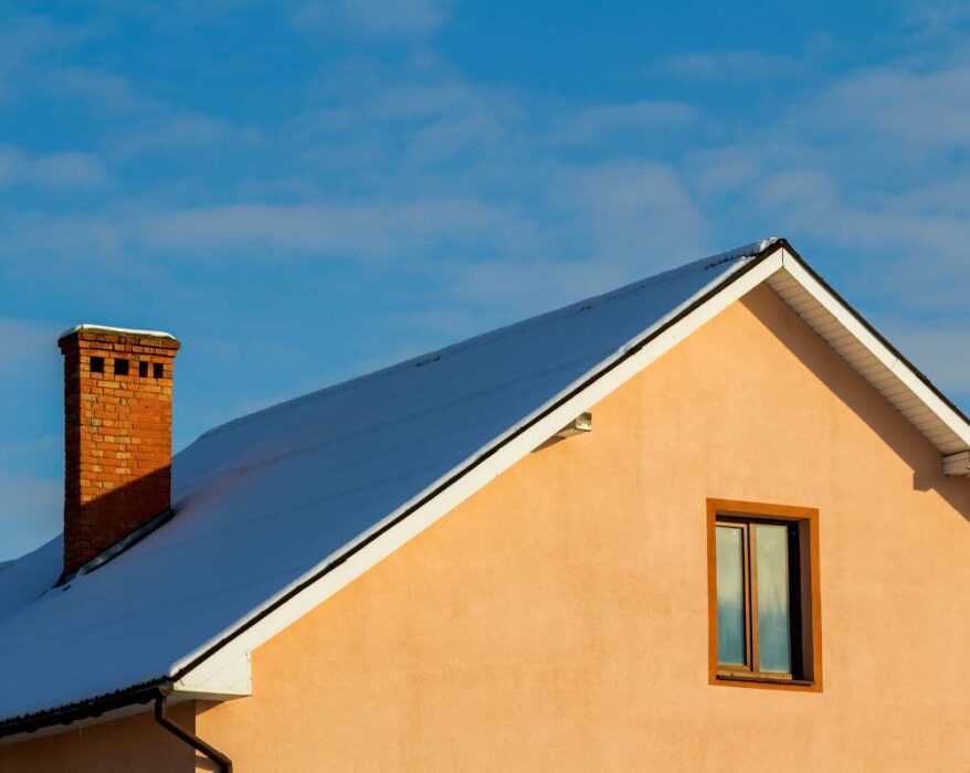 Roof of a new built house with nice window and chimney.