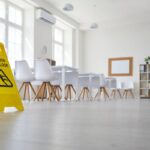 School classroom where cleaning service worker placed sign which reads Caution Wet Floor