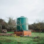 Green water tank in the countryside