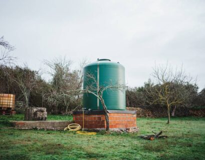 Green water tank in the countryside