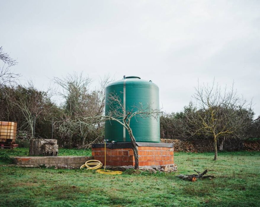 Green water tank in the countryside