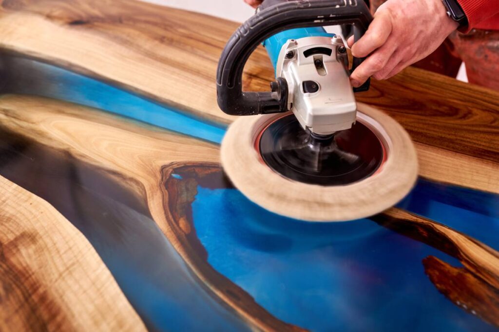 man polishing epoxy table close up