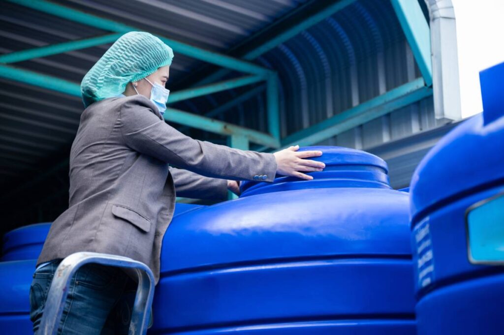 woman inspection engineer working in term of water quality checking control, food factory