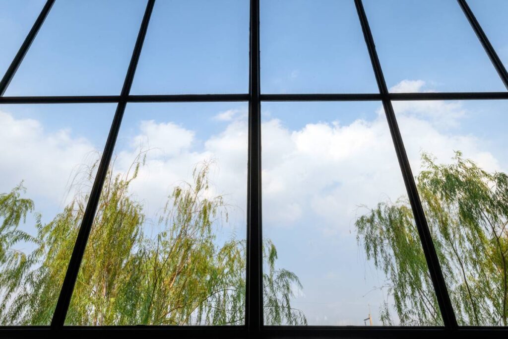 High windows design with green tree and blue sky