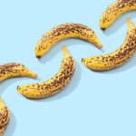 Spotted Banana pattern on blue background. Art food. Copy space