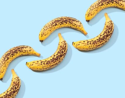 Spotted Banana pattern on blue background. Art food. Copy space