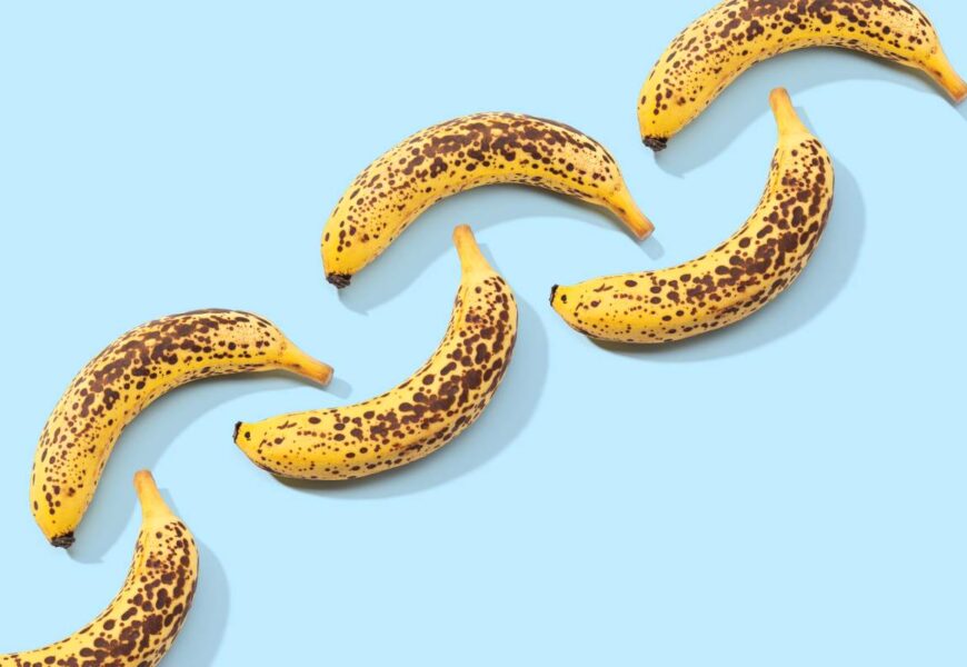 Spotted Banana pattern on blue background. Art food. Copy space