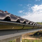 a metal black gutter on a roof covered with ceram 2023 11 27 05 16 19 utc (1)