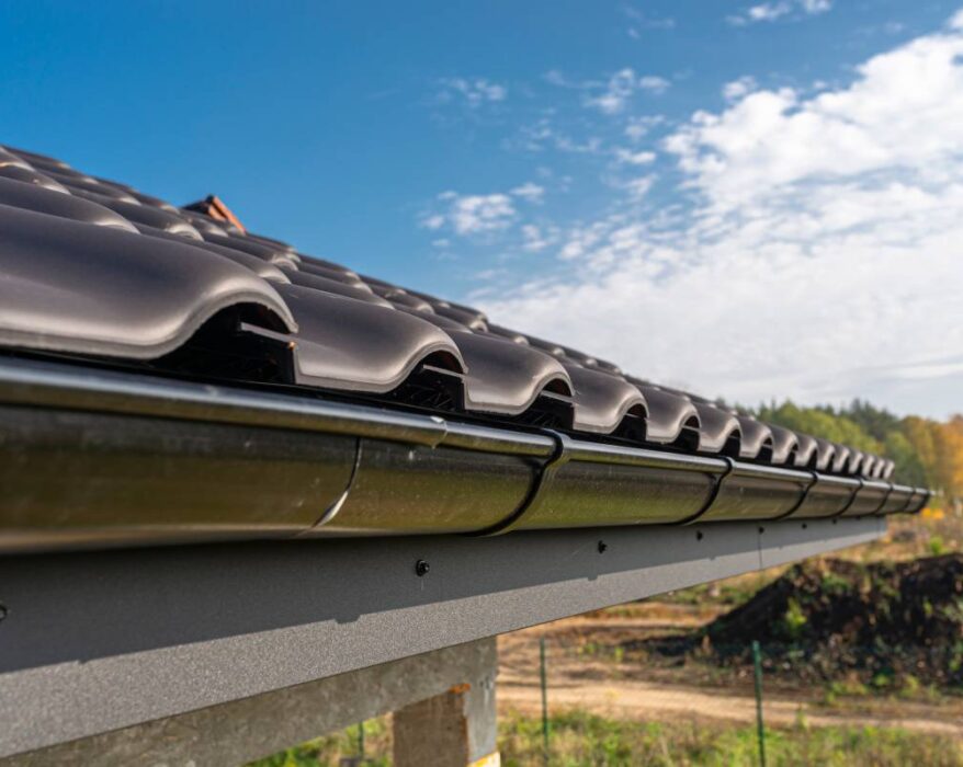 a metal black gutter on a roof covered with ceram 2023 11 27 05 16 19 utc (1)