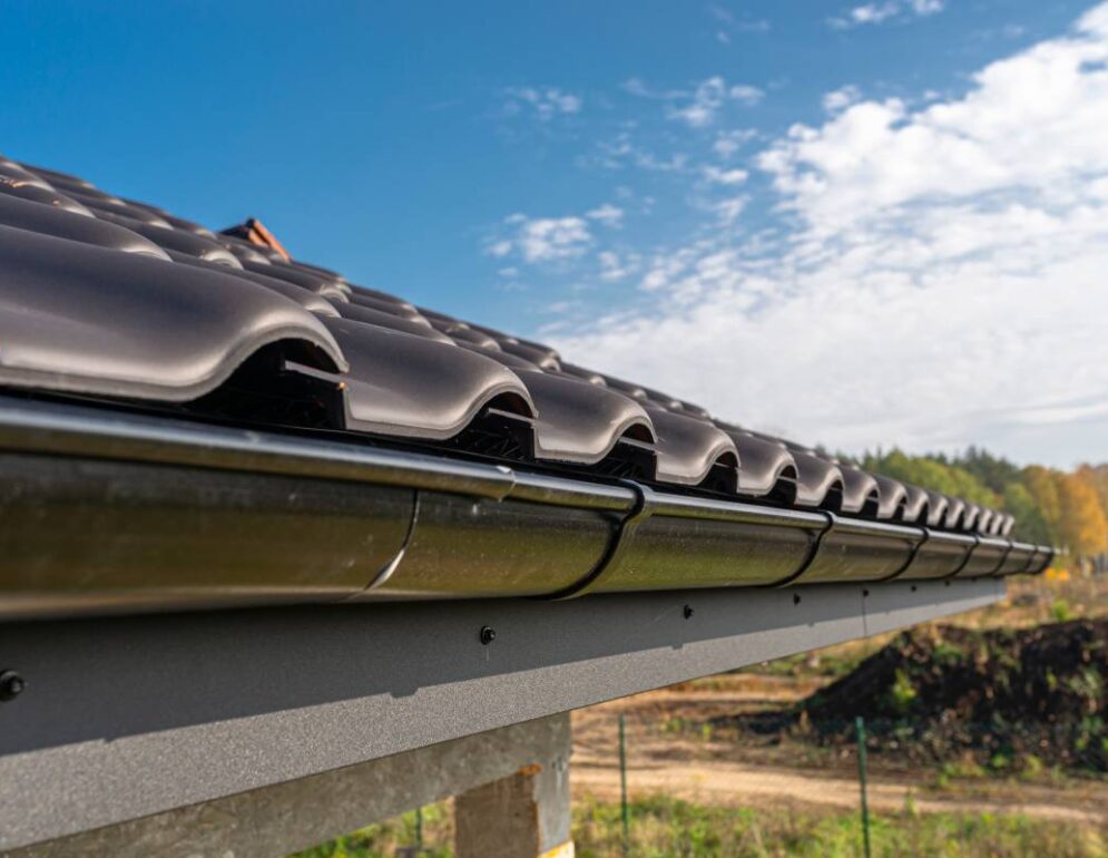 a metal black gutter on a roof covered with ceram 2023 11 27 05 16 19 utc (1)