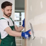 plasterer applying finish coat to wall Sydney